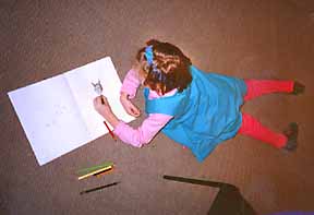a little girl creating a book at a workshop with Phoebe Stone