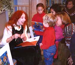 Photo of Phoebe with children at a book signing