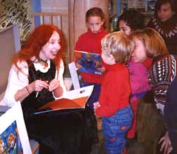 Photo of Phoebe with children at a book signing
